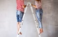 Unrecognizable couple painting walls in their house. Royalty Free Stock Photo