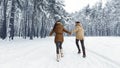 Unrecognizable Couple Running Through Winter Forest Holding Hands, Panorama