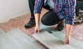 Female bricklayer placing tiles to install a floor