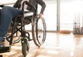 Unrecognizable disabled senior woman in wheelchair at home. Royalty Free Stock Photo