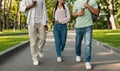 Unrecognizable diverse teen students walking in college campus after classes, walking together outdoors and talking Royalty Free Stock Photo