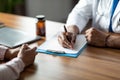 Unrecognizable doctor taking anamnesis of female patient Royalty Free Stock Photo