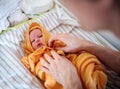 Unrecognizable father drying a newborn baby with a towel after bath at home. Royalty Free Stock Photo