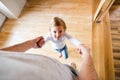 Unrecognizable father with his cute little daughter at home.