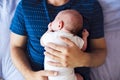 Unrecognizable father with his newborn baby son lying in bed Royalty Free Stock Photo