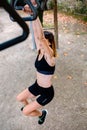 Unrecognizable woman doing monkey exercises on rings Royalty Free Stock Photo