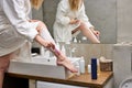 Unrecognizable Female In Bathrobe Shaving Legs In Bathroom Royalty Free Stock Photo