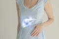 Woman in blue clothes holding virtual liver in hand. Handrawn human organ, detox and healthcare, healthcare hospital service