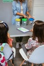 Teacher and students in an ecology classroom learning to recycle by sorting waste