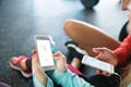 Unrecognizable fit couple in gym with smartphones. Royalty Free Stock Photo