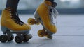 Unrecognizable girl performing moonwalk. Woman feet riding on rollerblades.