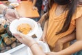 Unrecognizable girl receiving a plate with nacatamal, a typical dish from Latin America