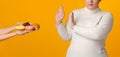 Unrecognizable Girl Rejecting Plate With Tasty Delicious Sweets, Showing Stop Gesture