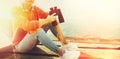 Unrecognizable Girl Sits On A Pier With Binoculars In Hand With Copy-Space