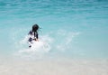 Unrecognizable girl splashing in crystal clear blue sea water. Royalty Free Stock Photo