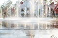 Unrecognizable Happy kids have fun playing in city dry water fountain on hot summer day