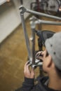 Unrecognizable hispanic man removing paint residue from a bike frameremo Royalty Free Stock Photo