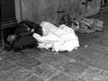 Unrecognizable Homeless Sleeping by a doorway.