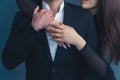 Unrecognizable interracial couple. Man wearing a white shirt and a suit jacket, woman hugging him and wearing a Royalty Free Stock Photo