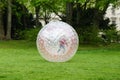 Unrecognizable kid zorbing in park