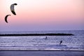 Kitesurfers surfing at sunset over the Mediterranean sea in Tel Aviv Israel Royalty Free Stock Photo