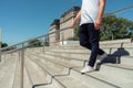 Unrecognizable latino man with a jean and white sneakers going down a cement stairs. Horizontal orientation Royalty Free Stock Photo