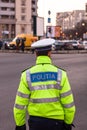 Unrecognizable local police agent. Romanian police man, traffic police man Politia Rutiera directing traffic in Bucharest,