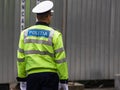 Unrecognizable local police agent. Romanian police man, traffic police man Politia Rutiera directing traffic in Bucharest,