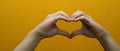 Unrecognizable making heart with hands isolated on yellow background. Love, Valentine& x27;s day, sign, symbol concept Royalty Free Stock Photo
