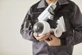 Unrecognizable male technician in uniform holding cctv security camera and going to install it Royalty Free Stock Photo