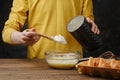 Unrecognizable man adds flour to a glass bowl Royalty Free Stock Photo