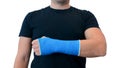 Man shows hand in plaster cast on white background Royalty Free Stock Photo