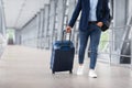 Unrecognizable Man In Casual Clothes Walking With Luggage At Airport Terminal Royalty Free Stock Photo