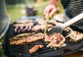 Unrecognizable man cooking seafood on a barbecue grill in the backyard. Close up. Royalty Free Stock Photo