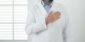 Unrecognizable man doctor portrait with man on heart - cardiologist professional job in white studio - prevention and healthcare