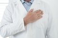 Unrecognizable man doctor portrait with man on heart - cardiologist professional job in white studio - prevention and healthcare