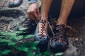 Unrecognizable Man Dresses Climbing Shoes For Climbing. Extreme Hobby Outdoor Activity Concept