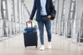 Unrecognizable Man With Hand Luggage Suitcase Walking At Airport Terminal, Cropped Shot Royalty Free Stock Photo