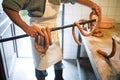 Unrecognizable man hanging homemade raw sausages on wooden stick