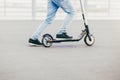 Unrecognizable man has active lifestyle, rides electric scooter, has hobby, rests as has weekend. People, hobby and driving concep Royalty Free Stock Photo