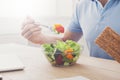 Unrecognizable man has healthy business lunch in modern office interior Royalty Free Stock Photo