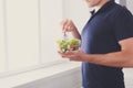 Unrecognizable man has healthy lunch, eating diet vegetable salad Royalty Free Stock Photo