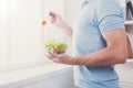 Unrecognizable man has healthy lunch, eating diet vegetable salad Royalty Free Stock Photo