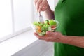 Unrecognizable man has healthy lunch, eating diet vegetable salad Royalty Free Stock Photo