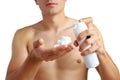 Unrecognizable man holding shaving foam in hands against white background