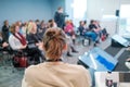 Unrecognizable man listening to speaker during business seminar