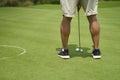 Unrecognizable man playing golf putting on green Royalty Free Stock Photo