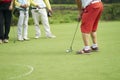 Unrecognizable man playing golf putting on green Royalty Free Stock Photo