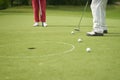 Unrecognizable man playing golf putting on green Royalty Free Stock Photo