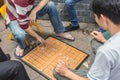 Unrecognizable man plays traditional board game known as chinese chess
